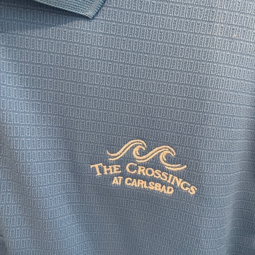 Blue adidas golf shirt, size large, from The Crossings course in Carlsbad CA.